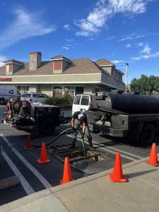 The Grease Company technicians pump an underground grease interceptor to remove accumulated grease and waste, helping maintain proper system function and reduce blockage risks.