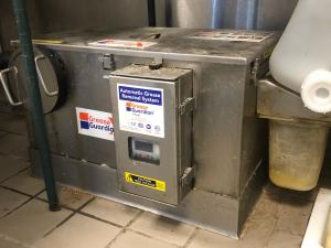 A large commercial grease trap helps separate fats, oils, and grease from kitchen wastewater before it enters the drainage system.