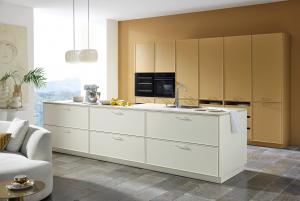 Caramel framed tall cabinets behind a Magnolia kitchen island, Nolte Evora Lack Caramel, German kitchen cabinets, Aksesuar Design Alexandria VA
