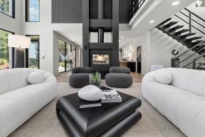 Luxury staged living room at 1400 Aqua Vista Lane in Henrico, Virginia, with a two-story black fireplace and furnishings by Jsquared Interior Staging and Design.