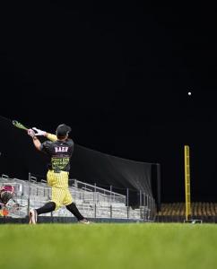 Jake Baer hits a homer deep into the cornfield behind the field
