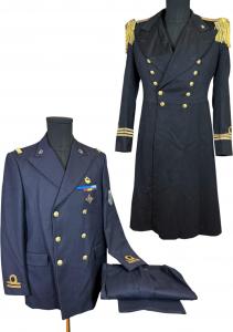 Two Italian Navy uniforms, comprising a dark blue officer’s frock coat with gilt naval buttons, together with a double-breasted Navy uniform with frogman/diver insignia. Estimate: $250-$450
