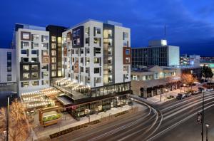 Hotel exterior showing location in downtown Cherry Creek and patio string lights.