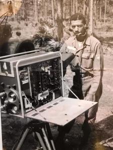 Mac McGill in his military days in uniform with his camera opened to show the inside