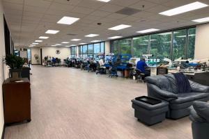 Wide interior view of Durable Dental Lab's new Buffalo Grove laboratory with dental technicians, workstations, and specialized equipment.