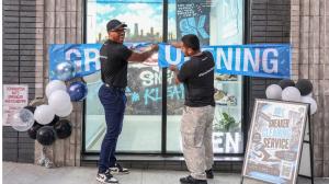 Devonn Vidal, Founder and CEO of Sneakky Klean, and Alfredo Figueroa, Managing Director, smile as they cut a ceremonial ribbon at the grand opening of Sneakky Klean's new Brooklyn location at 1211 Fulton Street in New York on October 9, 2026, National Sneaker Day