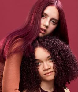 Two models with their hair dyed Bleach London Atomic Cherry