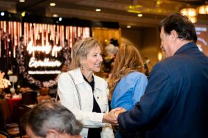 Design Tech Homes owner greeting an attendee at the 2026 BBB Awards for Excellence ceremony in Houston.