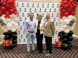 Design Tech Homes owners celebrating their 2026 BBB Pinnacle Award win while holding the crystal award at the BBB Awards for Excellence ceremony.