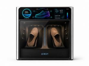 AiRET AX1 cleaning a pair of suede loafers, with a display showing material analysis for the upper, lining, midsole and sole