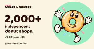 Doughie, a smiling glazed-donut mascot, dances beside text celebrating more than 2,000 independent donut shops across all 50 states and DC.