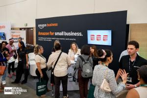 Visitors gather around the Amazon Business booth at a previous Small Business Expo, with the Small Business Expo logo at lower left.