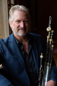 A photo of Eric Rigler holding his pipes. Eric recorded and played the Academy Award winning song from Braveheart. his work includes Titanic, Lord Of The Rings, and many more