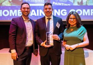 Michael Sutton, Owner/Founder, Kind Home Painting, holding the Denver Business Journal's Partners In Philanthropy Award at awards event in Denver, Colorado alongside a presenting sponsor from The Rose Foundation and Denver Business Journal