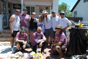 Photo of Kind Home Painting employees posing together during a give back volunteer sessiono the Denver community through the company's Community Outreach and Painting with Kindness programs.