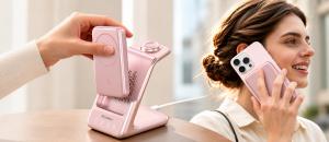 Pink RORRY AuraDock charging station with a detachable magnetic power bank being lifted from the dock, alongside a woman using a smartphone.
