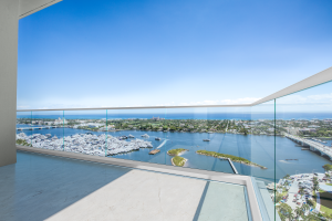 Rendering of the view from a balcony at The Plaza of the Palm Beaches, with glass railings overlooking the Intracoastal Waterway, Palm Beach and the Atlantic Ocean.