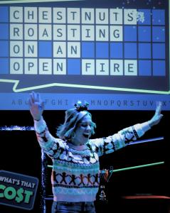 Guests participate in holiday-themed game show challenges featuring head-to-head competitions, interactive props, and live game show hosts at Game Show Battle Rooms Austin.