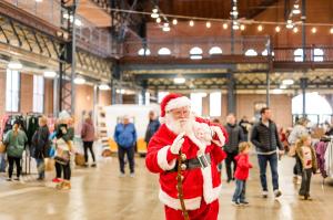 Santa walks through the Illinois Local Holiday Market on Small Business Saturday