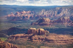 View from plane looking downward at cathedral rock during a bright afternoon