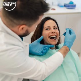 Dentist examining a female patient's teeth during a dental examination