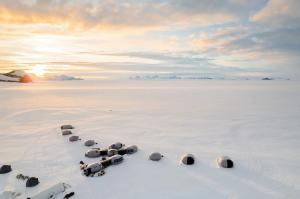 Aerial view of White Desert's dome camp on the Antarctic ice at sunset