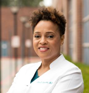 Dr. Dina Strachan in a white coat
