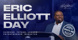 Navy blue graphic reading “Eric Elliott Day” in large white letters, with a photo of Eric Elliott in a blue plaid blazer speaking into a microphone at a podium, a circular “Oct, 14 Eric Elliott Day” seal, and the words “Husband. Father. Leader. Entreprene