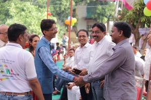 Hiten Bhuta greeting community members at an event associated with Sakar Trust’s rural social service initiatives in South Gujarat.