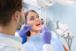 Female patient receiving a dental examination from a dentist
