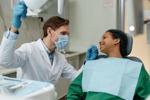 Teenager receiving a routine dental checkup from a dentist