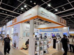 KJM exhibition booth with orange and white signage and shelves displaying home screens.