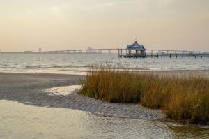 Beach and marsh at low tide in Ocean Springs, Miss. in the late afternoon with the Ocean Springs-Biloxi bridge visible in the background