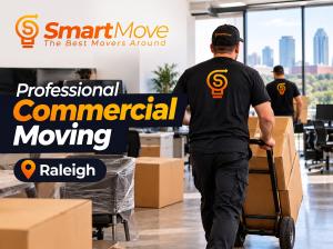 Professional movers carrying boxes in an office during a commercial relocation.