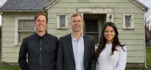 Three members of the Better Off Home Buyers team standing in front of a single-story house