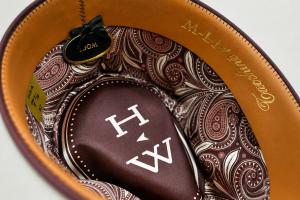 Close-up of the HeadWest Reserve Collection hat interior, featuring a premium leather sweatband and signature Western satin paisley lining, exclusively designed with Tacchino Hat Co.