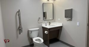 Accessible bathroom with grab bar and roll-under vanity plumbed by Fox Valley Plumbing & Backflow at Judson University's Lindner Tower in Elgin, Illinois