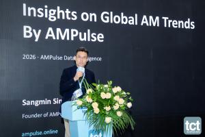 Sangmin Lee speaking at TCT Shenzhen 2026 with Insights on Global AM Trends by AMPulse on the screen.