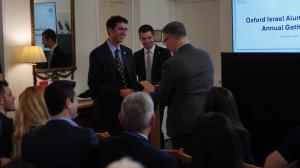 Oxford Israel Alumni Society Co-Chairs Simon Kotlerman and Dr. Aviv Yehezkel standing with British Ambassador to Israel Simon Walters before an audience at the Ambassador's residence