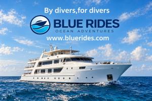 A beautiful liveaboard diving vessel is shown against a blue sky and blue ocean with the blue rides logo over top.