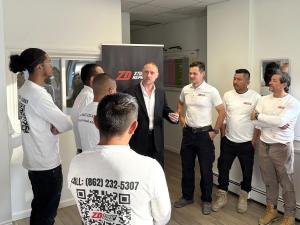 Zoltan Dicso, founder of ZD Stucco Repair, meets with his team
