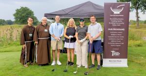 Brother Tien, Brother Gary, Michael A. Root, Kelly Draper, Amanda Afton Martin and David D. Marsh at the 2026 Kemp Klein Charity Golf Classic supporting Capuchin Soup Kitchen.