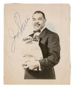 This 5 inch by 4 ½ inch black and white photograph signed by Joe Louis, depicting the champ in a jacket and bow tie carrying a bag of groceries, carries an estimate of $500-$700.