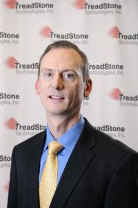 Dan Russell headshot with step and stagger TreadStone Technologies logo backdrop. Latest member of the Board of Directors for TreadStone Technologies