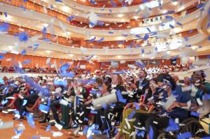 Guests seated at the Renée and Henry Segerstrom Concert Hall laugh and celebrate as blue and white confetti falls on them during Orange County's Miracle of Mobility fundraising gala.