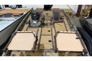Interior of Excel EX 203 camo boat with folding pedestal seats, side console and brown helm seats