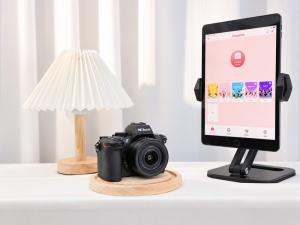 A mirrorless camera with the ChackTok photo booth app on an iPad