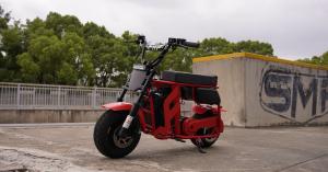 Red FRP Moto M3 electric mini bike parked on concrete