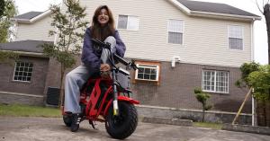Rider sitting on a red FRP Moto M3 electric mini bike