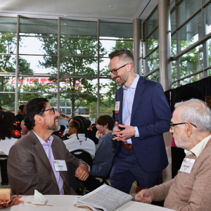 Three men at a table, Marco Arnone connects with members of the Temple University College of Engineering community during the 2026 Fall Scholarship Celebration.